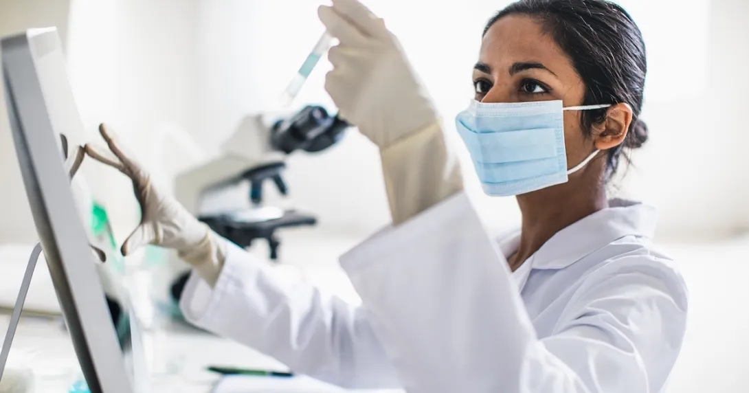 Technician analyzing the content of a test tube Technician analyzing the content of a test tube